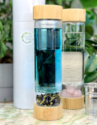 Glasflasche mit Kristallen und Teesieb
